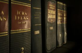 Detailed close-up of law and regulation books on a bookshelf, emphasizing education and knowledge.
